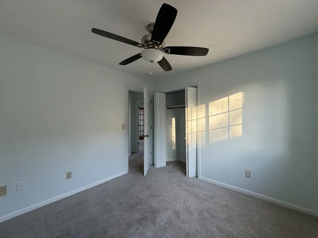 a view of empty room with ceiling fan