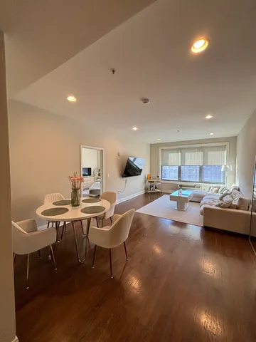 a view of a dining room with furniture and wooden floor