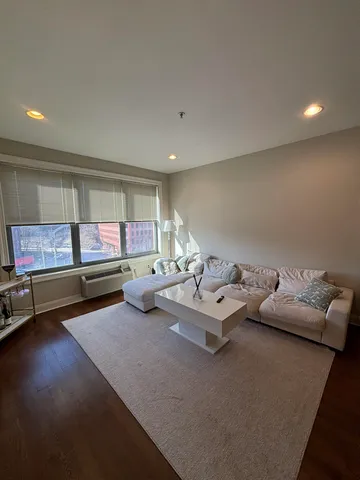 a living room with furniture and a pool table