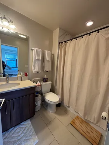 a bathroom with a double vanity sink and a toilet