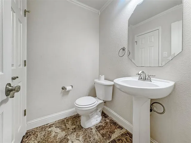 a bathroom with a sink toilet and a mirror