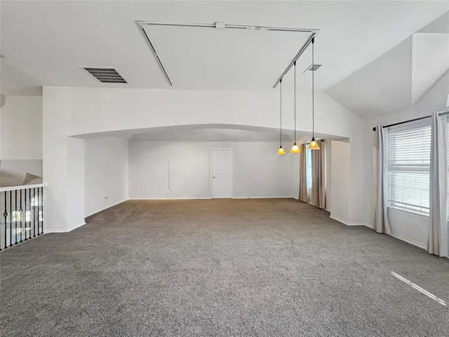 a view of empty room with ceiling fan