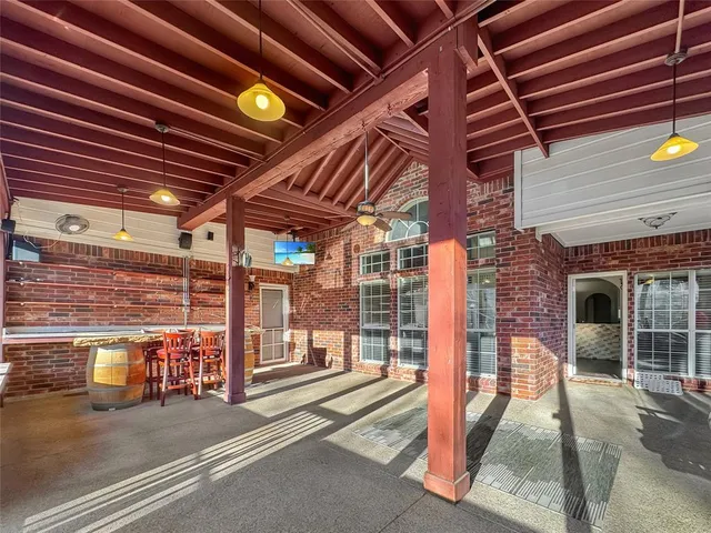 a view of a porch with a table and chairs