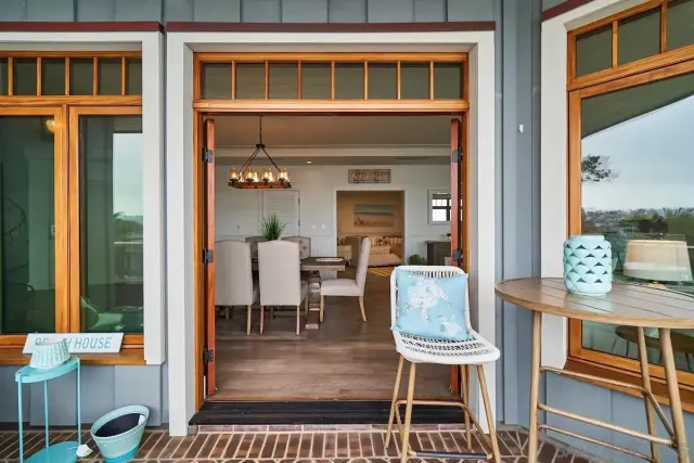 a balcony with wooden floor table and chairs
