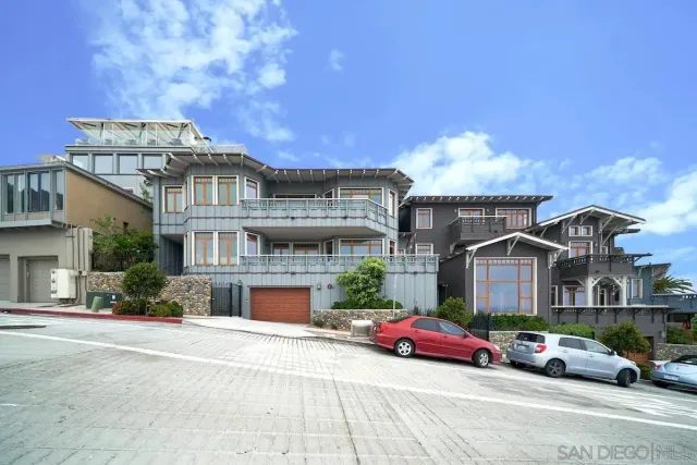 a front view of a house with a garden and parking