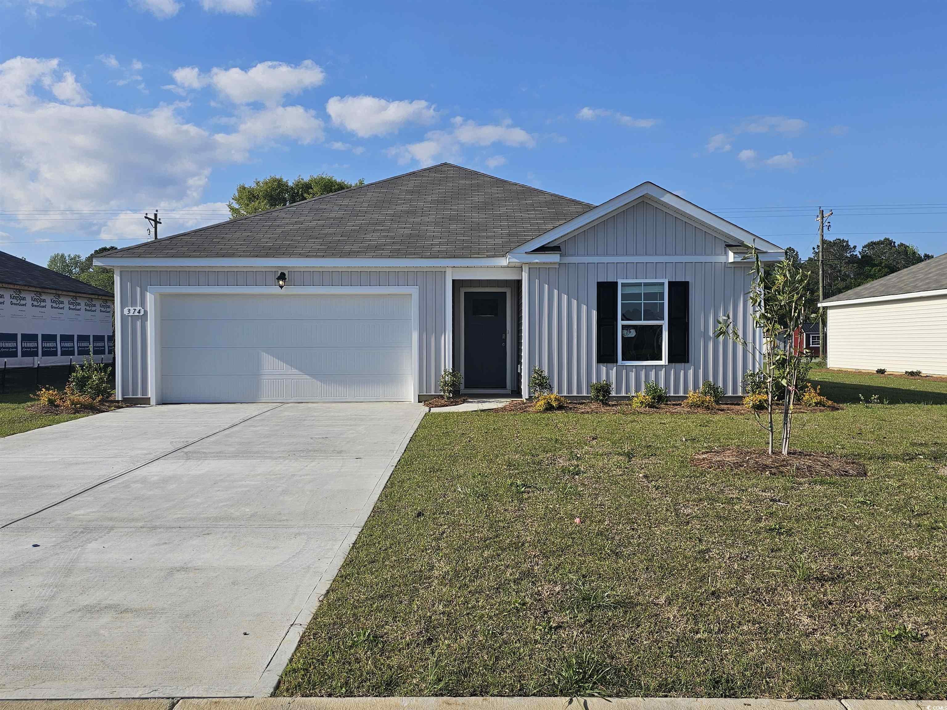 Ranch-style house with board and batten siding, an