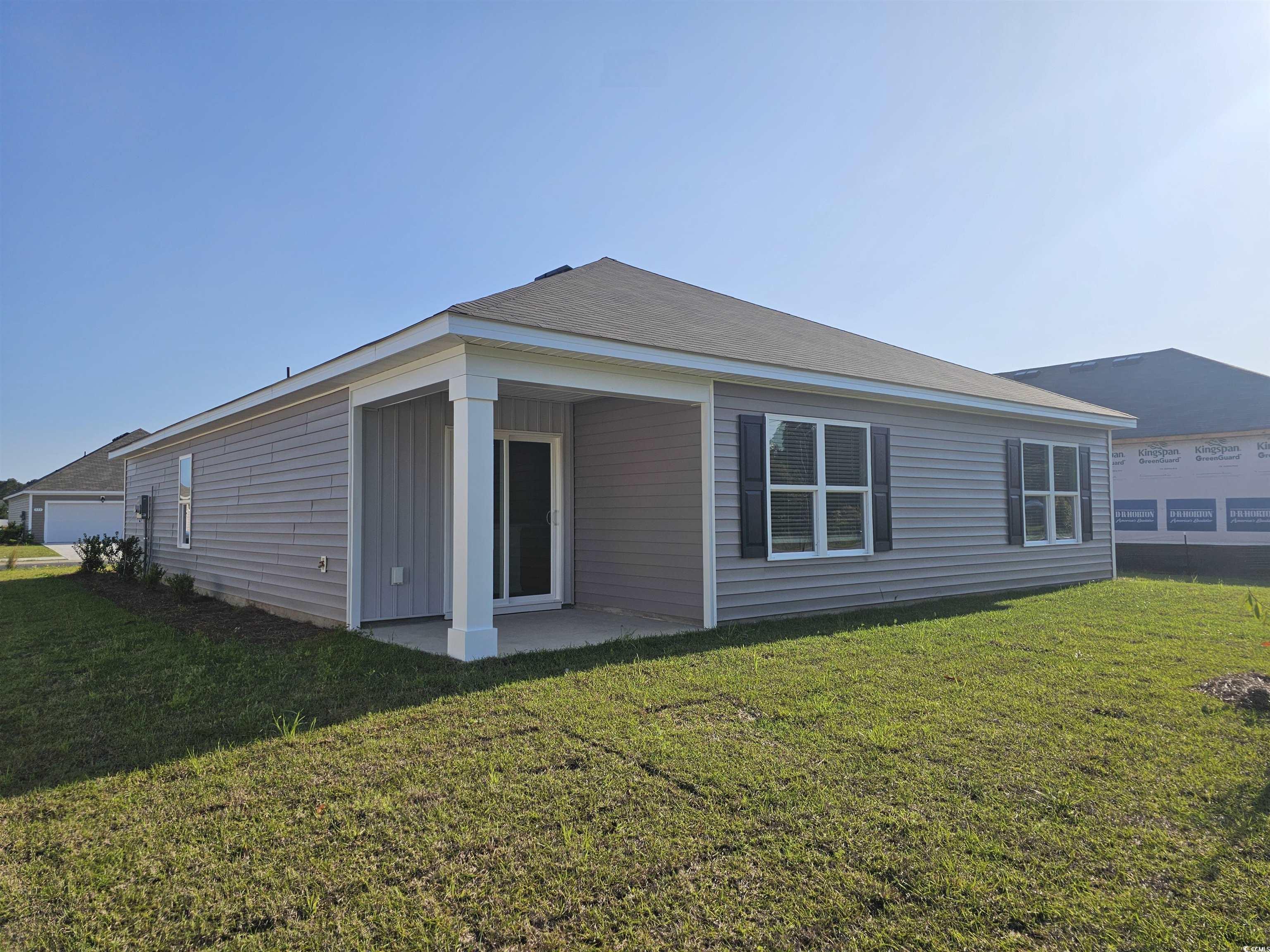 374 Jeff Waters Circle Longs, SC 29568 - Photo 2 of 22 Rear view of property featuring a lawn and a patio