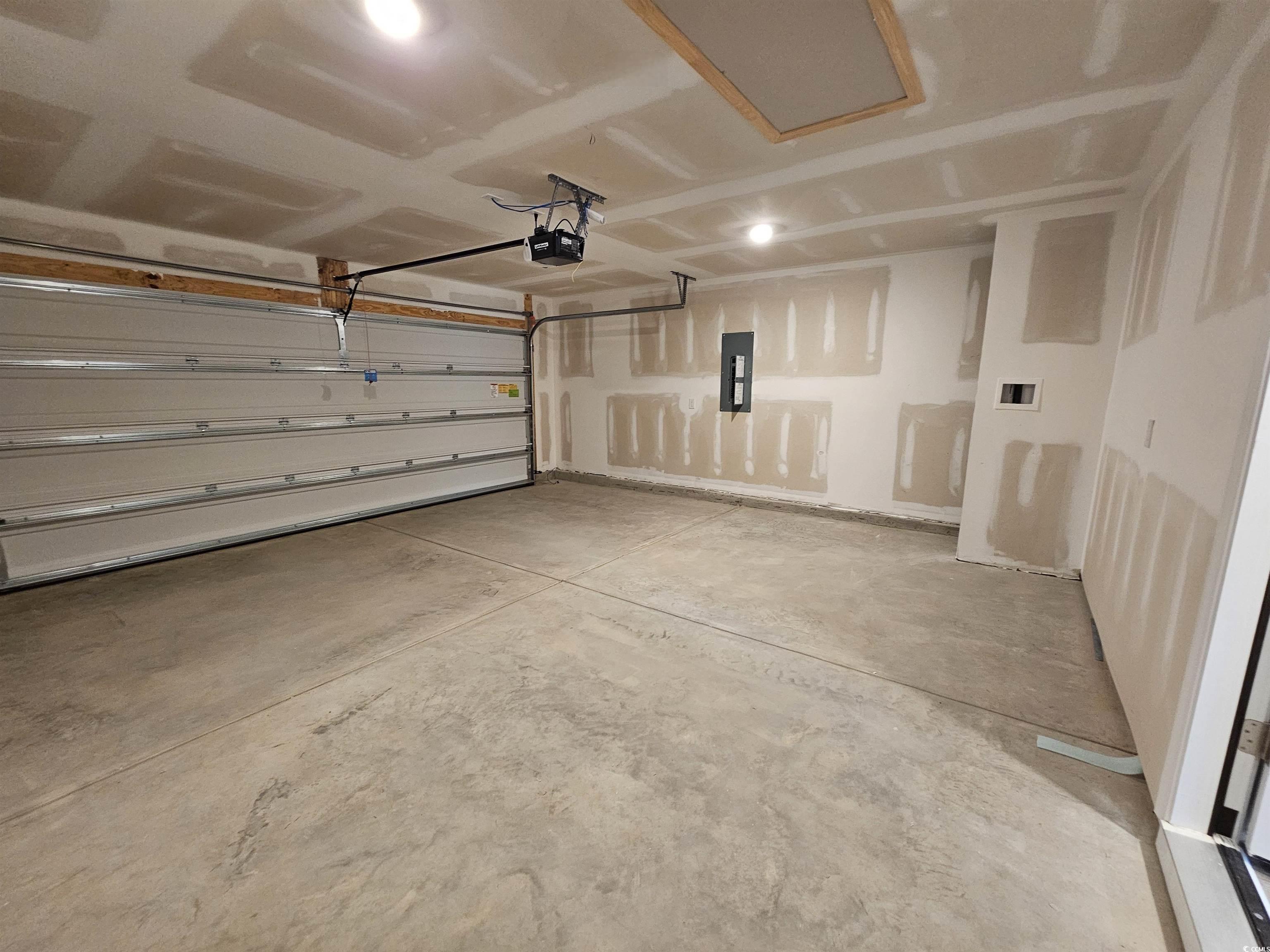 374 Jeff Waters Circle Longs, SC 29568 - Photo 21 of 22 Garage featuring a garage door opener and electric