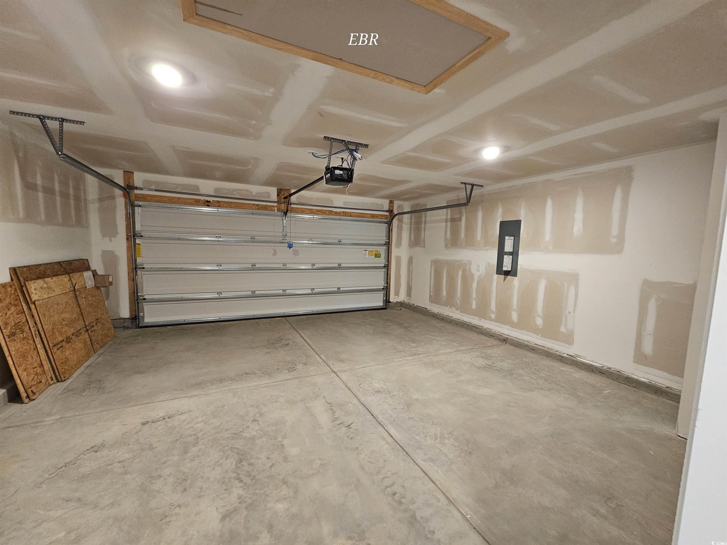 374 Jeff Waters Circle Longs, SC 29568 - Photo 22 of 22 Garage featuring electric panel and a garage door