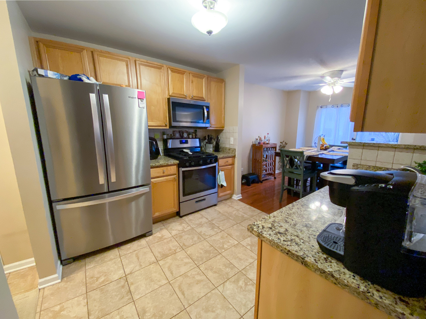 652 Chestnut Ridge, Unit 652 Minooka, IL 60447 - Photo 6 of 31 a kitchen with stainless steel appliances granite countertop a refrigerator stove a sink dishwasher and microwave