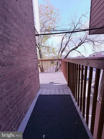 a view of a porch with wooden floor