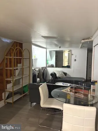a bedroom with two beds and painting on the wall