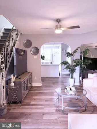 a living room with furniture and a wooden floor