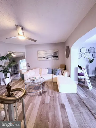 a living room with fireplace furniture and a wooden floor
