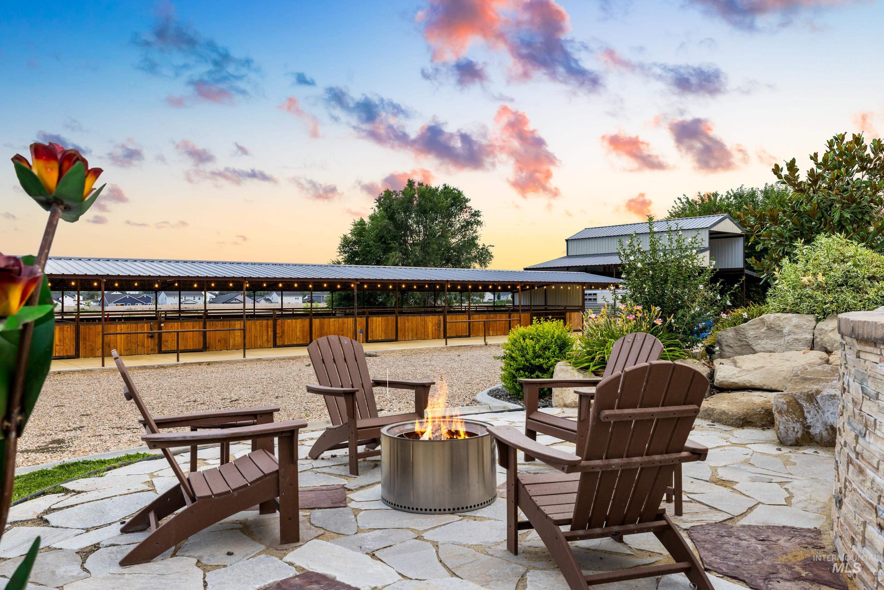 9819 Foothill Road Middleton, ID 83644 - Photo 45 of 49 Patio terrace at dusk featuring an outdoor fire pit and a patio area