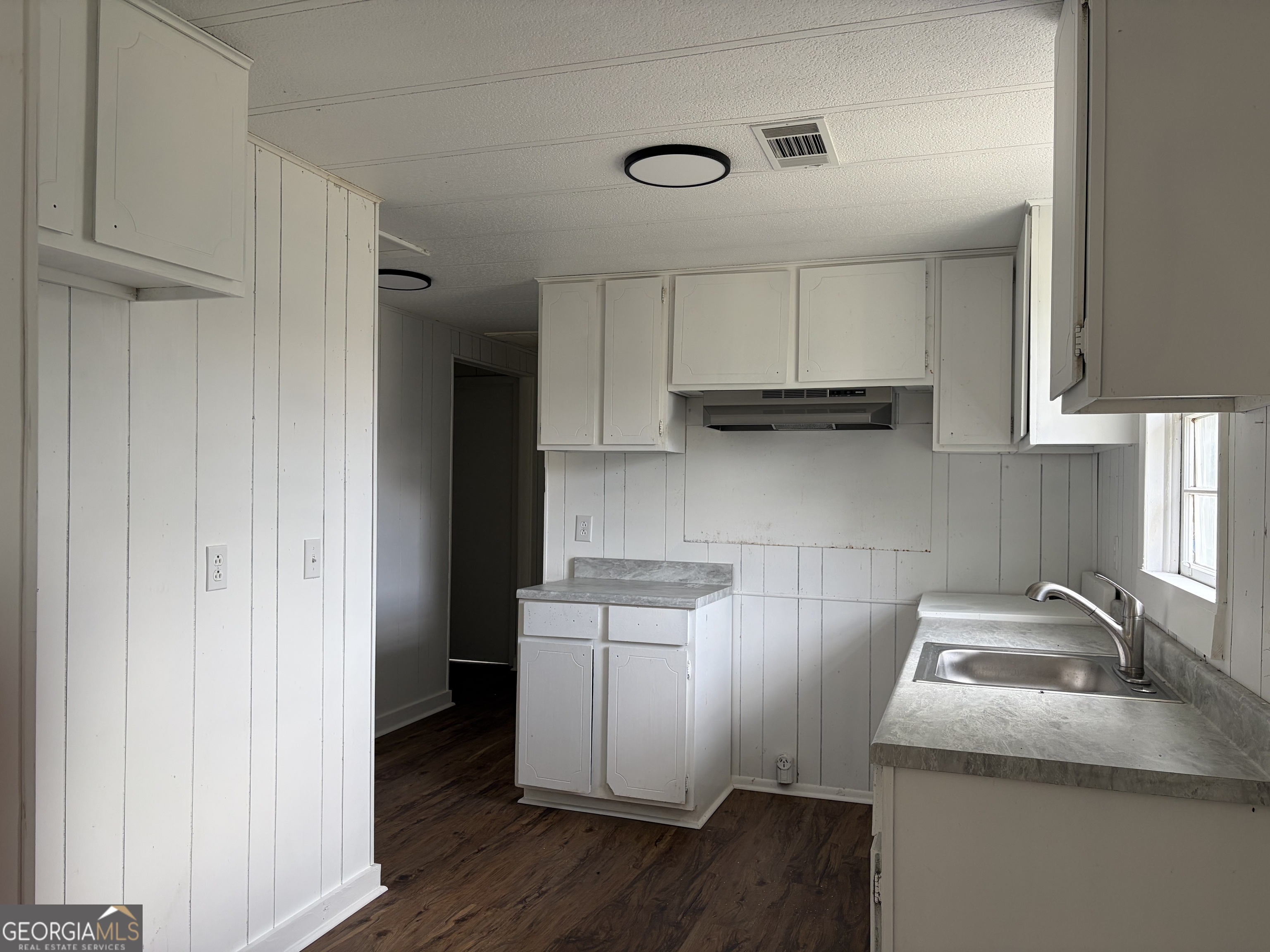 184 Belvue Avenue Lyons, GA 30436 - Photo 4 of 11 a kitchen with a sink a stove and cabinets