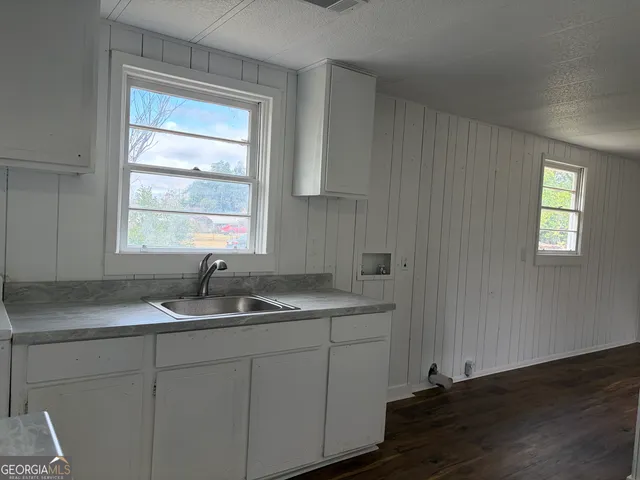 a kitchen with sink cabinets and window