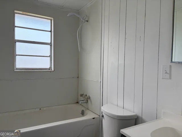 a bathroom with a toilet and a bathtub