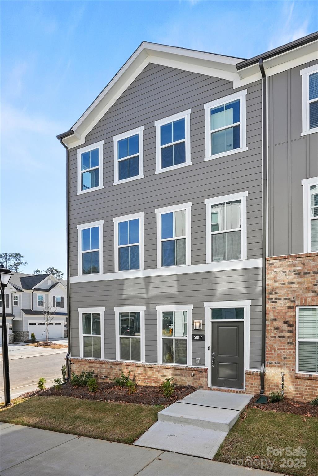 6004 Runoff Court Charlotte, NC 28262 - Photo 4 of 11 a front view of a house with a yard