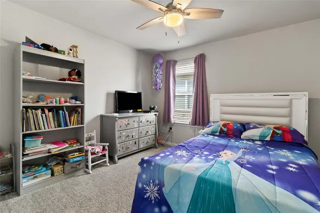 a bedroom with a bed furniture and a flat screen tv