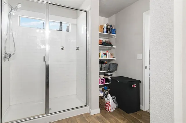 a view of walk in closet with clothes and shoes