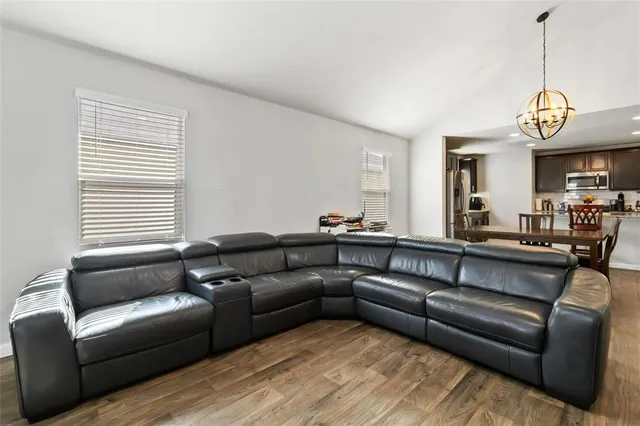 a living room with a couch and a chandelier