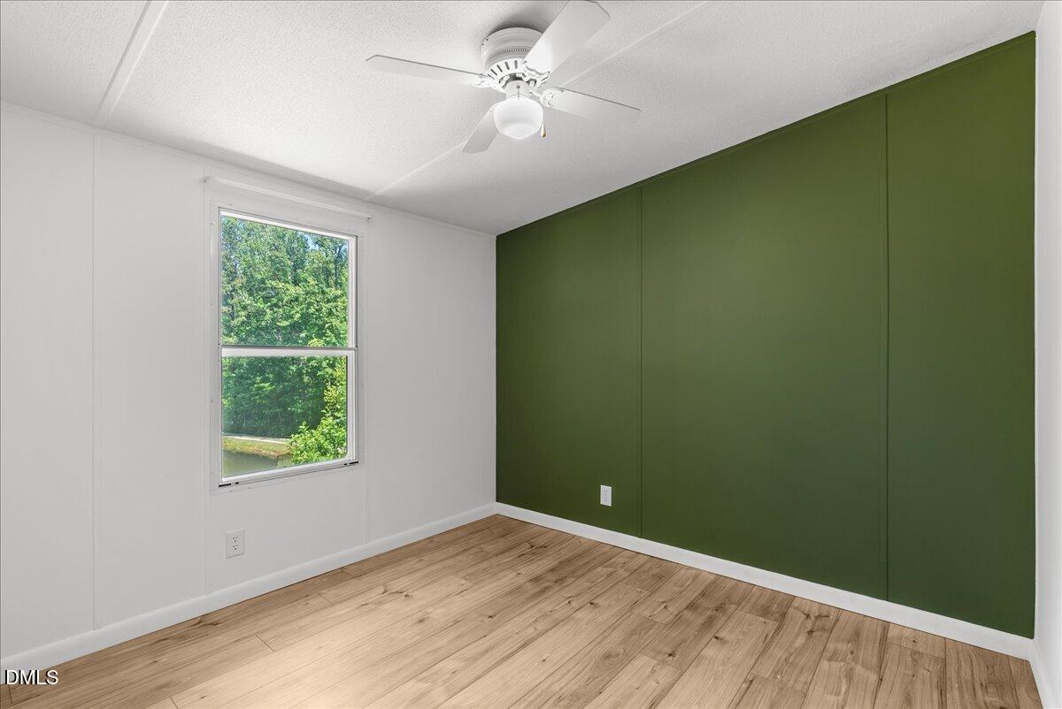 1111 Stoney Mountain Road Rougemont, NC 27572 - Photo 14 of 30 an empty room with a window and a ceiling fan