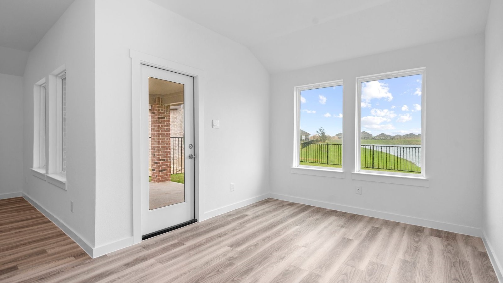 13 Robin Court Angleton, TX 77515 - Photo 11 of 27 a view of an empty room with wooden floor and a window