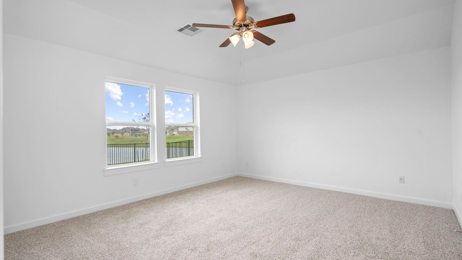 13 Robin Court Angleton, TX 77515 - Photo 14 of 27 an empty room with a window and a fan