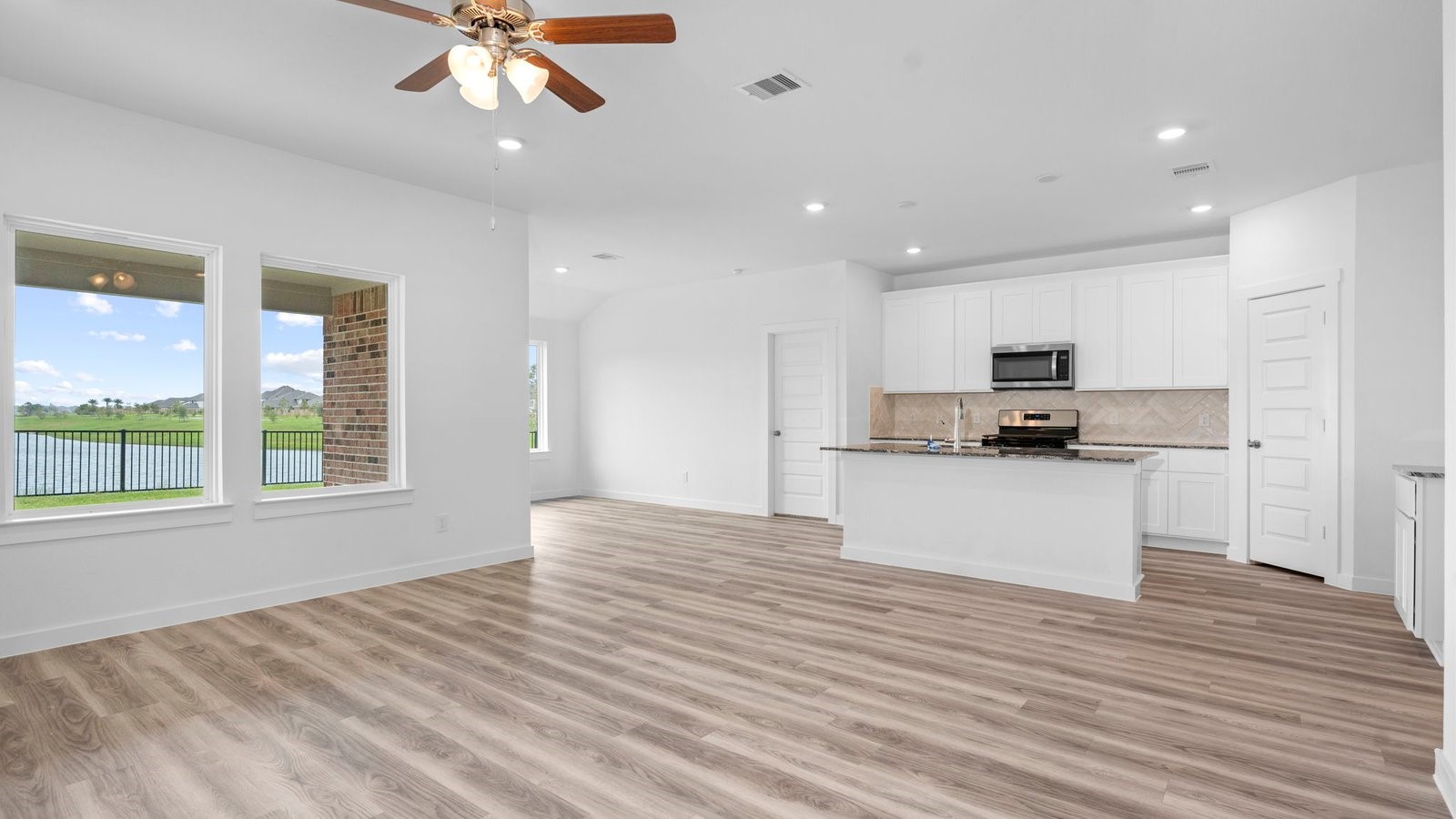 13 Robin Court Angleton, TX 77515 - Photo 10 of 27 a view of kitchen with kitchen island stainless steel appliances wooden floor and window