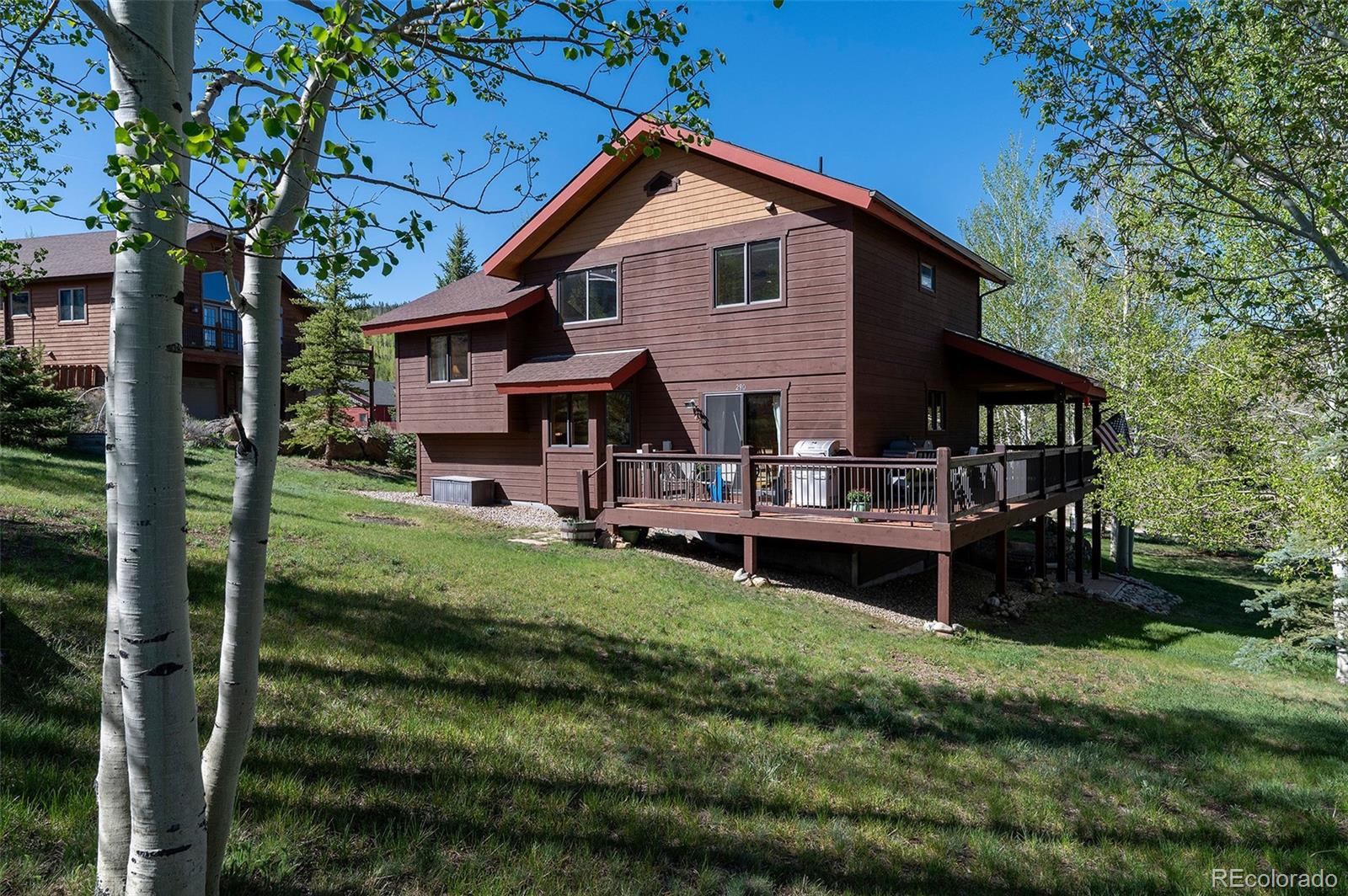 290 Village Road Granby, CO 80446 - Photo 35 of 45 a front view of a house with a garden and plants