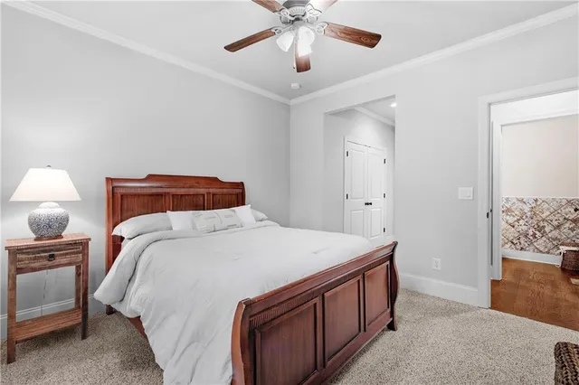 a kitchen with stainless steel appliances granite countertop a refrigerator a sink dishwasher a stove and white countertops with wooden floor