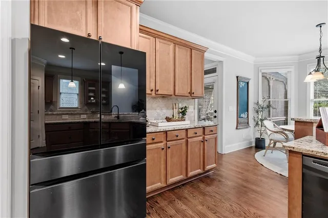 a kitchen with stainless steel appliances granite countertop a stove a sink and a microwave