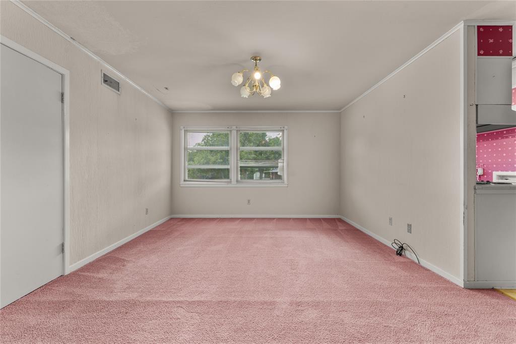 3216 MacArthur Drive Waco, TX 76708 - Photo 19 of 39 an empty room with windows and chandelier