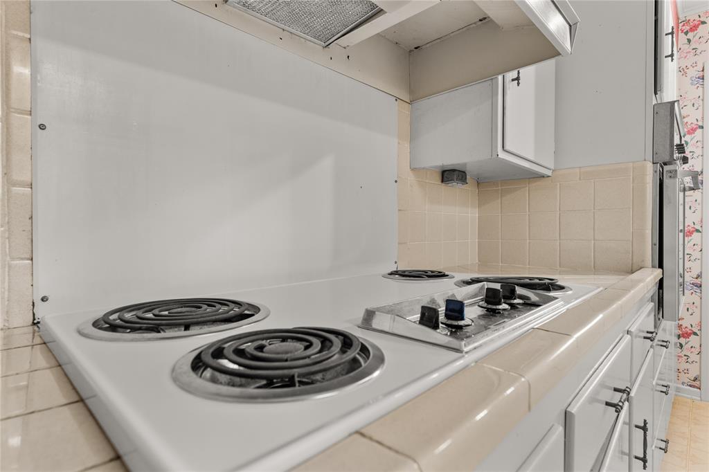 3216 MacArthur Drive Waco, TX 76708 - Photo 27 of 39 a kitchen with a stove and a sink with cabinets