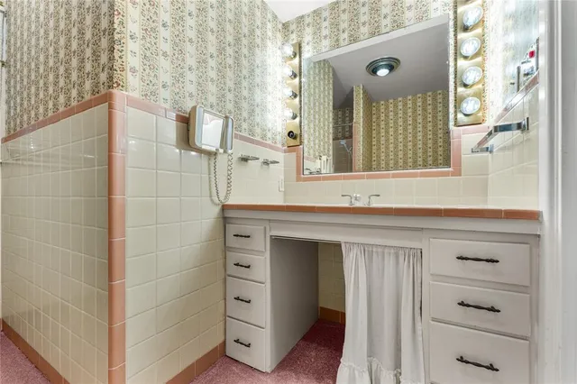 an empty room with closet and a bathroom