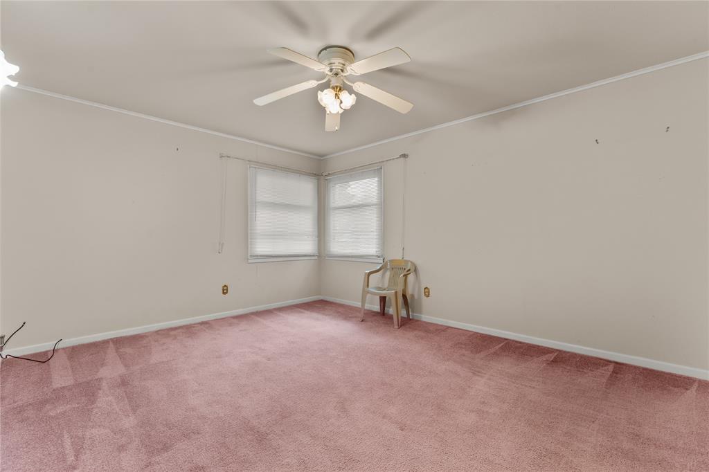 3216 MacArthur Drive Waco, TX 76708 - Photo 35 of 39 an empty room with chandelier fan and windows