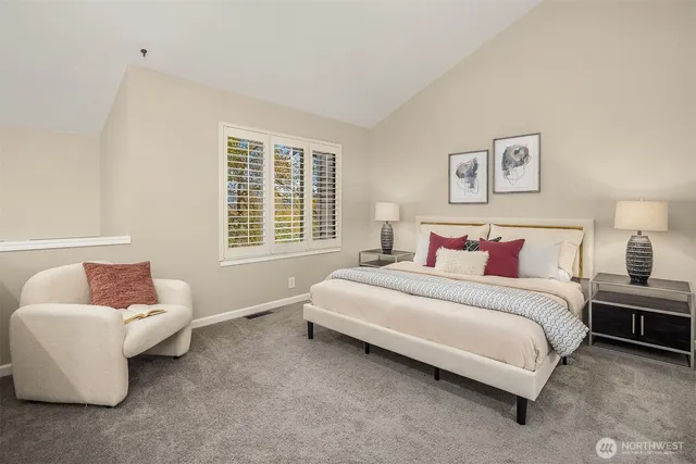 a spacious bedroom with a bed and a couch