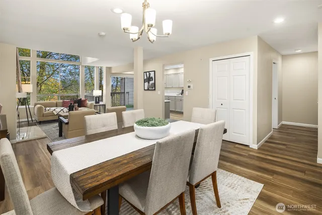 a view of a dining room with furniture wooden floor and chandelier