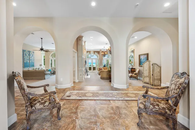 a living room with furniture a chandelier and a chandelier