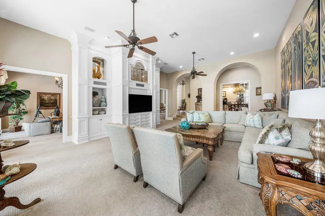 a dining room with furniture a chandelier and wooden floor