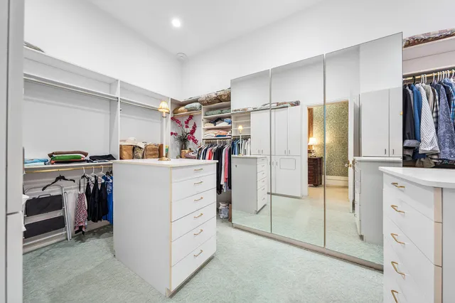 a living room with furniture a flat screen tv and a chandelier
