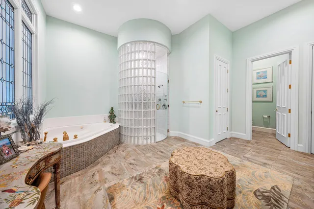 a bathroom with a granite countertop sink a mirror and a bathtub