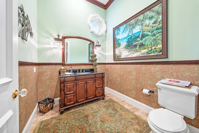a bathroom with a double vanity sink toilet mirror and window