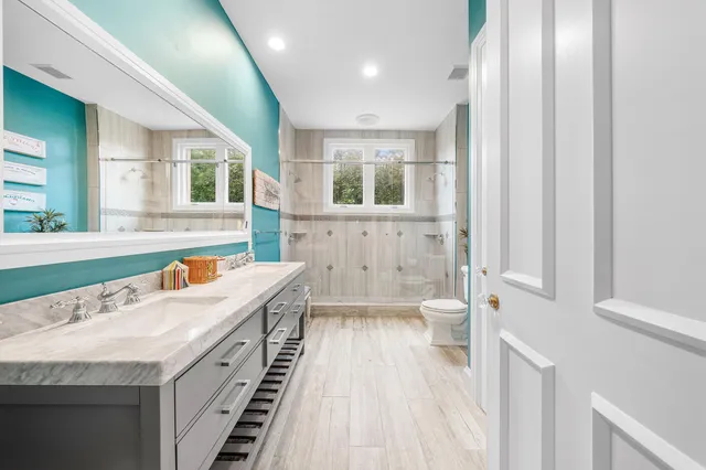 an aerial view of a house with a yard basket ball court and outdoor seating