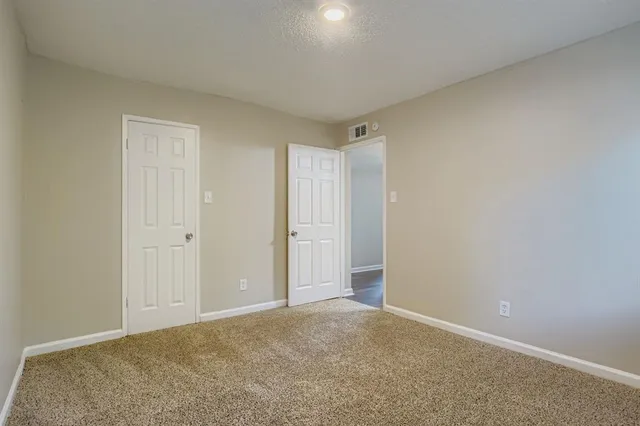 a view of an empty room and closet area