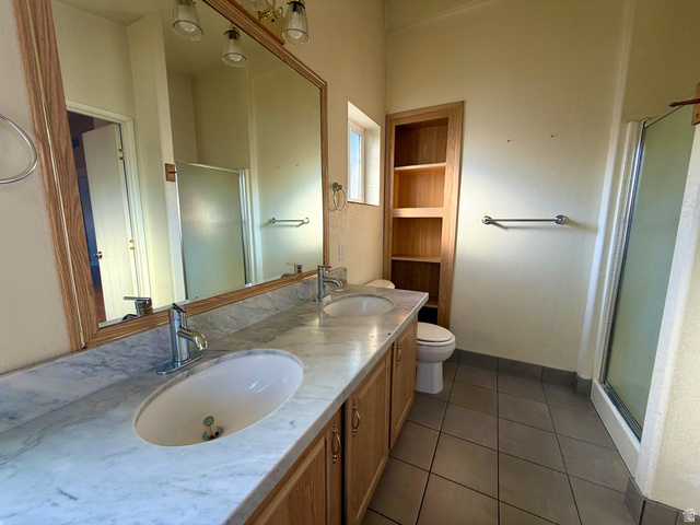 1025 North 300 West, Unit 1 Springville, UT 84663 - Photo 13 of 35 Bathroom with a stall shower, double vanity, and dark tile patterned flooring