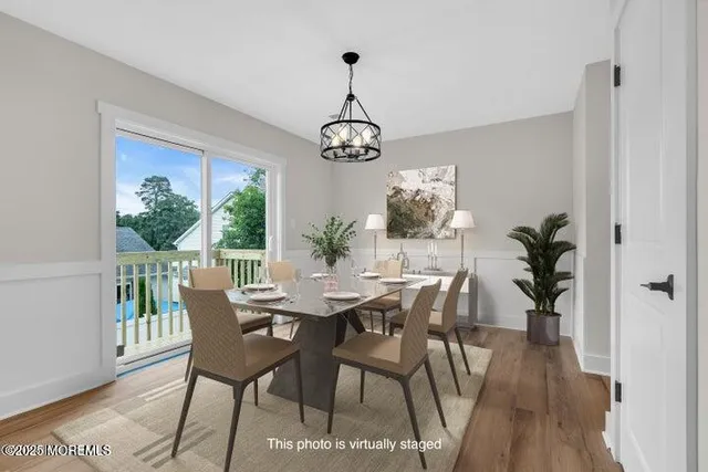 a kitchen with stainless steel appliances a stove a sink and white cabinets with wooden floor