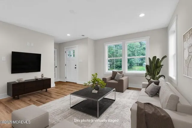 a view of a kitchen with wooden floor and a sink