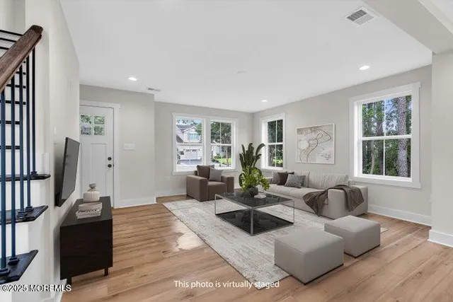 a view of a kitchen with wooden floor and windows